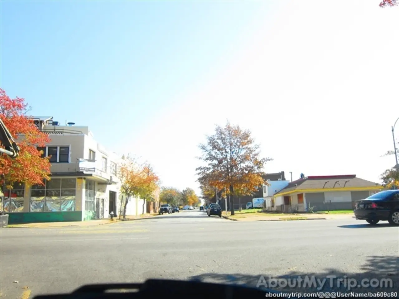 In the image I can see a place where we have some buildings, houses and also I can see some trees,...