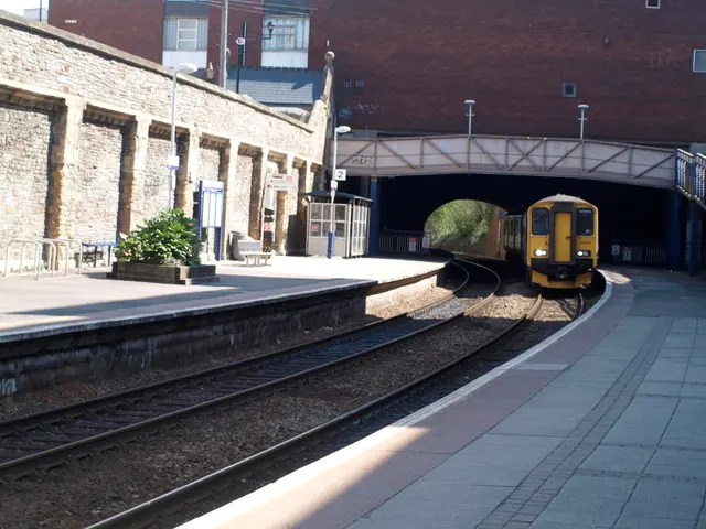 In this image there is a train moving on the railway tracks. On the either sides of the tracks...
