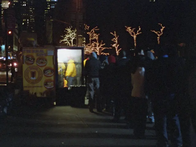 At the bottom of the image on the footpath there are many people standing. And also there is a...