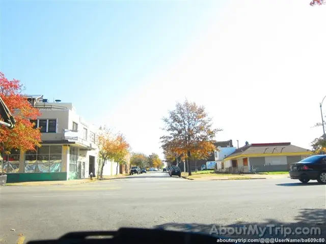 In the image I can see a place where we have some buildings, houses and also I can see some trees,...