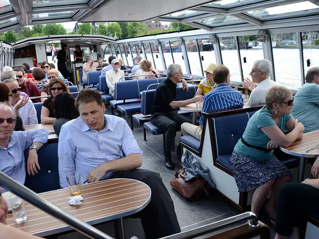This image is clicked inside the boat. In the image there are so many seats on which there are so...