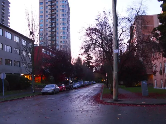 The picture is taken outside a city on the street. On the right side of the picture there are...